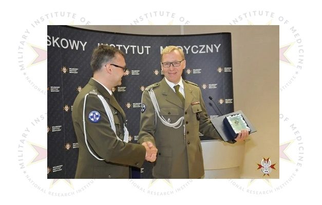 Uroczystość wręczania nagrody na drugim planie grafiki półprzezroczyste logotypy WIM.