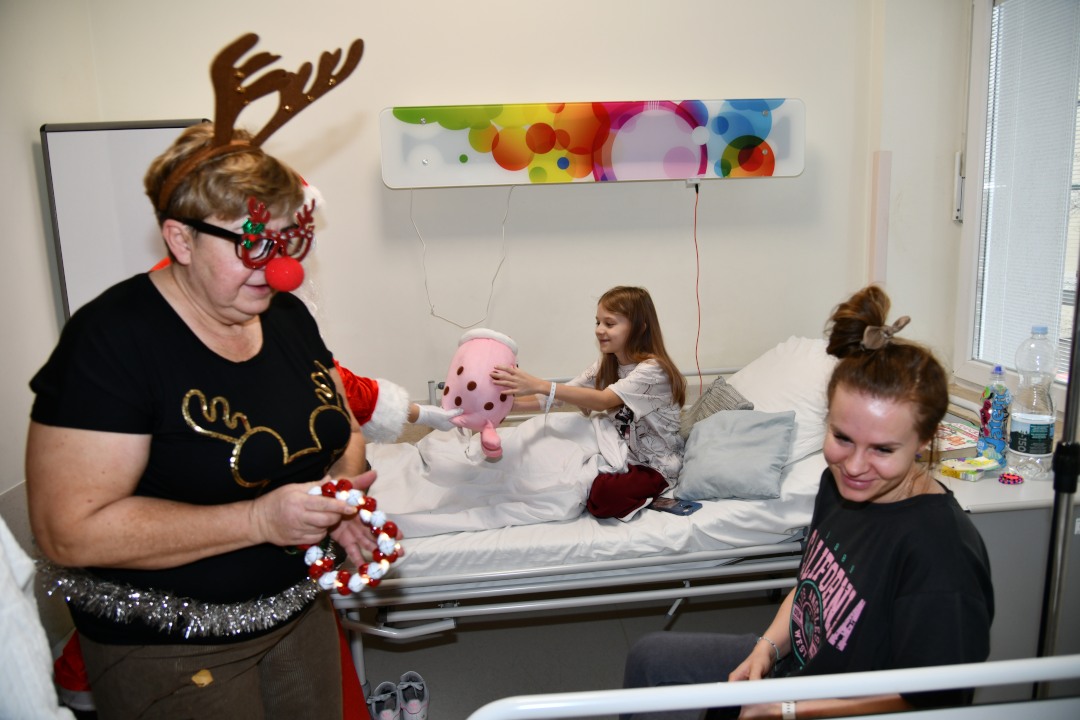 Pani reniferowa i mama pacjenta obok szpitalnego łózka na sali szpitalnej.