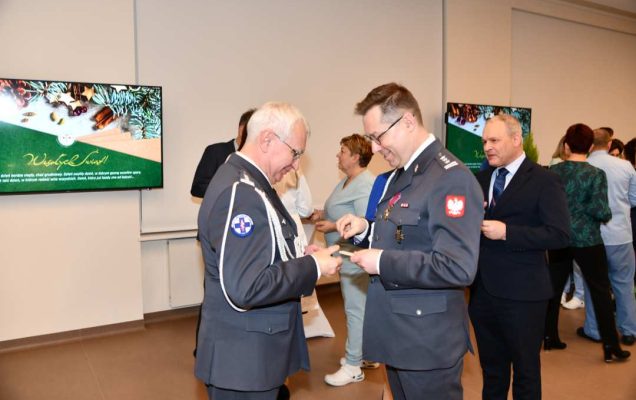 Goście i pracownicy dzielą się opłatkiem.