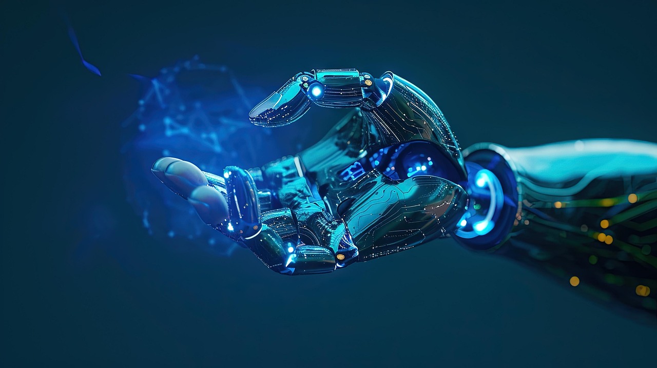 Realistyczna, futurystyczna grafika przedstawiająca metaliczną, cybernetyczną dłoń robota wyciągniętą do przodu na ciemnoniebieskim tle. Dłoń jest zbudowana z błyszczących elementów mechanicznych i obwodów, z niebieskimi, świecącymi diodami w stawach i na powierzchni palców. W jej wnętrzu unosi się półprzezroczysta, świetlista kula z siecią połączonych linii i punktów, przypominająca hologram lub wizualizację danych. Całość symbolizuje zaawansowaną technologię, sztuczną inteligencję i interakcję człowieka z maszyną.