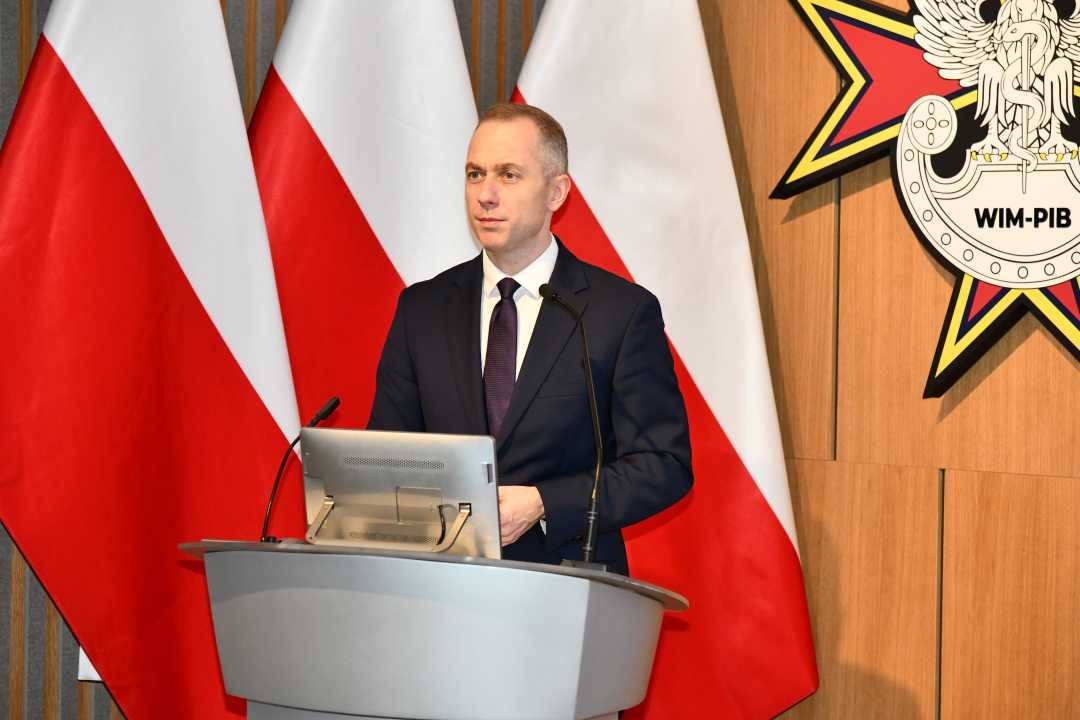 Władysław Kosiniak-Kamysz przy mównicy. Za jego plecami flaga Polski i logotyp WIM-PIB.